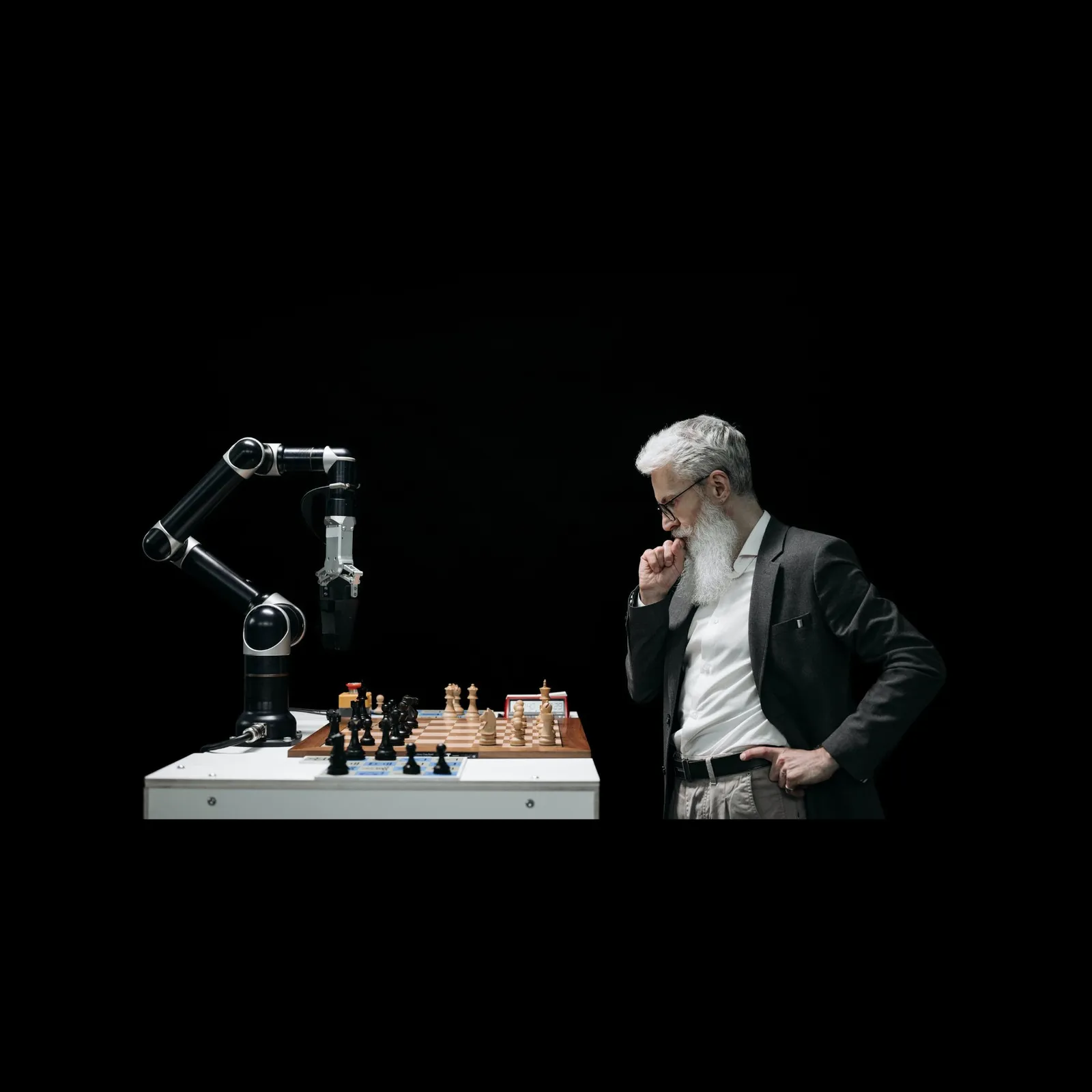 A robotic arm playing chess against a man, symbolizing AI reasoning